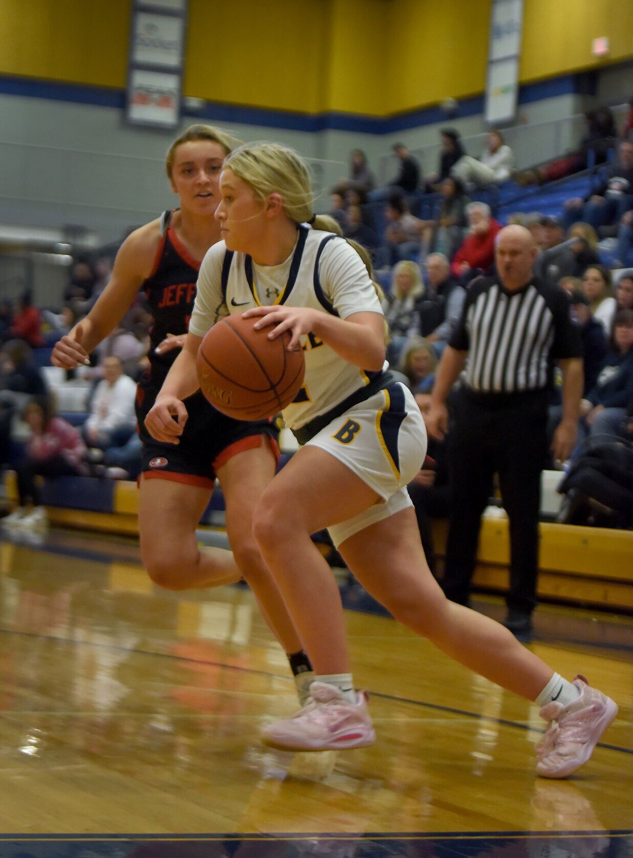 Battle's Maliyah Miller dribbles the ball while Jefferson City's Regan Nilges runs